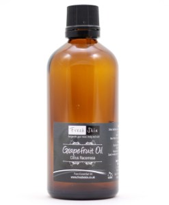 Beauty Isn't Just Skin Deep | Bioglan Beauty Collagen Gummies & Beauty Collagen Effervescent A short cylindrical clear glass bottle full of some medium orange liquid with a medium purple label that has fresh skin beauty Grapefruit Oil written in bold black writing on it, on a white background.