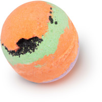 A large spherical shaped green, purple and orange striped bath bomb that has a small crack on the front of it with some pieces of sea salt coming out of it, on a white background.