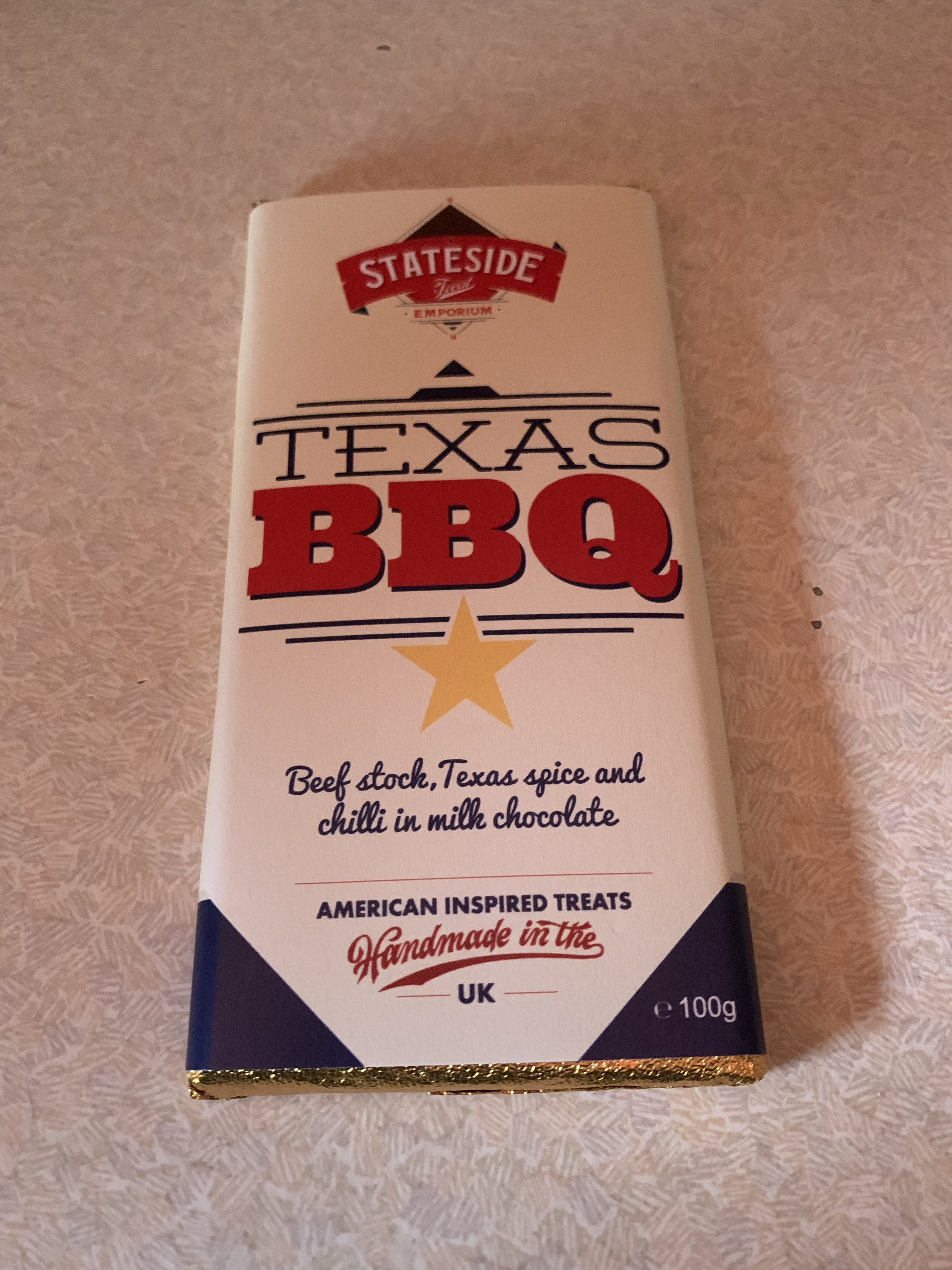 A Brilliant Brazilian Barbecue | Cabana Leeds Road To Rio Summer Menu Launch A tall rectangular white cardboard box that has Stateside Texas Barbecue Spiced Milk Chocolate written in bold red and black writing and a picture of a gold star on it, on a white background.