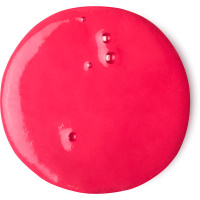 A small circular puddle of dark red shower gel, on a white background.