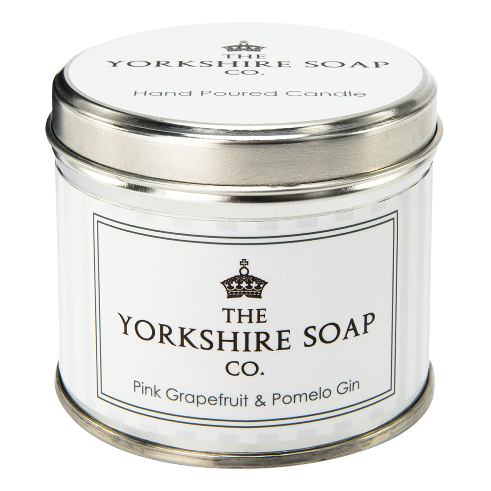 Getting Drunk On It's Scent | The Yorkshire Soap Company Pink Grapefruit & Pomelo Gin Tin Candle A short cylindrical silver tin with a silver lid and a white label that has The Yorkshire Soap Company written in bold black writing, Pink Grapefruit & Pomelo Gin Tin Candle written in bold rose gold writing, and a picture of a rose gold crown on it, on a white background.