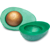 A large dark green avocado shaped block of soap that has a sparkly gold avocado stone in the centre of it, on a white background.