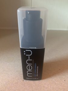 A short rectangular black plastic bottle with a clear lid that has Men-ü written in bold white writing and Matte Moisturiser written in bold blue writing on it, on a white background.
