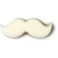 A small cream moustache shaped block of solid Beard oil, on a white background.