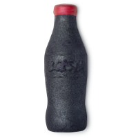 A large black old fashioned fizzy drink bottle shaped bubble bar that has a red cap and Lush engraved on top of it, on a white background.
