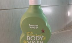 A tall cloud shaped bright green plastic bottle with a white plastic pump lid that has Soaper Duper Zesty Sicilian Lemon Body Wash written in bold white writing on it, on a white background.