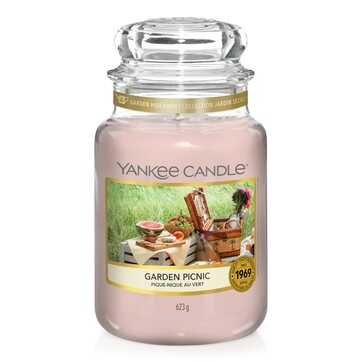 What I Thought of the Yankee Candle Advent House 2014 A tall glass jar full of some pale pink wax with a label that has Yankee Candle written in black writing, Garden Picnic written in black writing, and a picture of a picnic blanket in a field on it, on a white background.