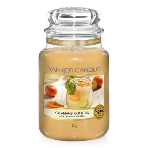 What I Thought of the Yankee Candle Advent House 2014 A tall glass jar full of some creamy yellow wax with a label that has Yankee Candle written in black writing, Calamansi Cocktail written in black writing, and a picture of a cocktail glass that has a slice of orange and a slice of lime inside it and a sprig of Mint coming out of the top of it on it, on a white background.