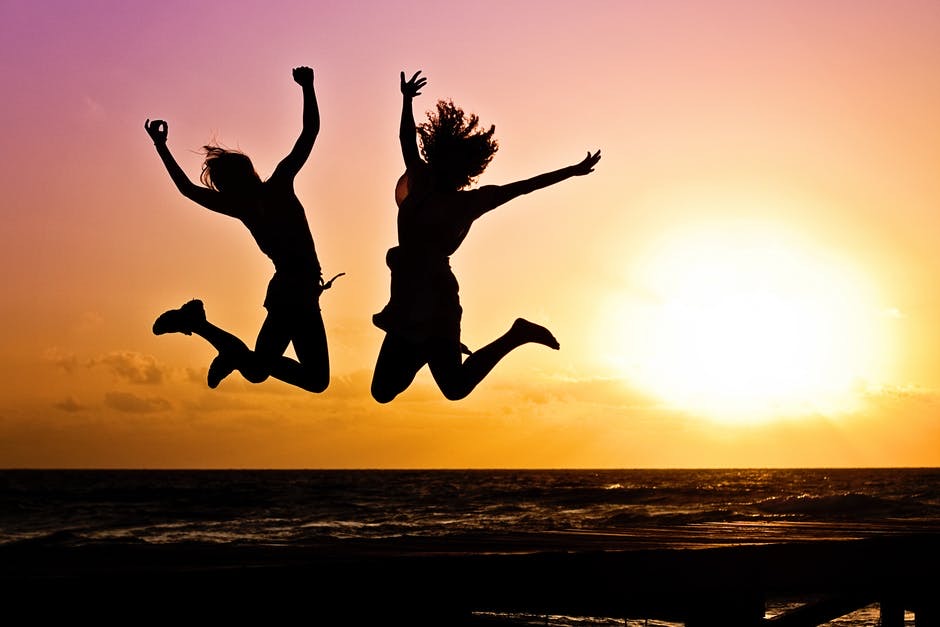 His Special Day | Father's Day 2020 Bloggers Collaborative Giveaway Some silhouettes of two excited people jumping in front of a bright orange Sunset.