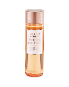 Getting A Glow While I Get My Fruit & Veg | Aldi Lacura Healthy Glow Glycolic Toner & Healthy Glow Retinol Toner A tall cylindrical clear plastic bottle full of some translucent gold liquid with a bright gold lid that has Aldi Lacura Healthy Glow Glycolic Toner written in bold black writing on it, on a white background.