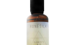 A short cylindrical brown glass bottle with a black rubber pipette lid and a white and gradient light blue label that has runesilk elements Air beard oil written in bold black writing and a picture of a light blue triangle on it, on a white background.