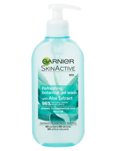 A tall flat cylindrical white plastic bottle with a white plastic pump lid that has Garnier Naturals written in bold black writing, Aloe Extract Gel Wash For Normal Skin written in bold white writing, and a picture of a dark green aloe vera plant on it, on a white background.