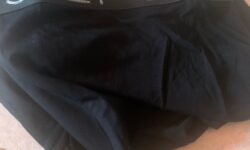 A large pair of black trunks that has Step One written in bold white writing on them, on a white background.