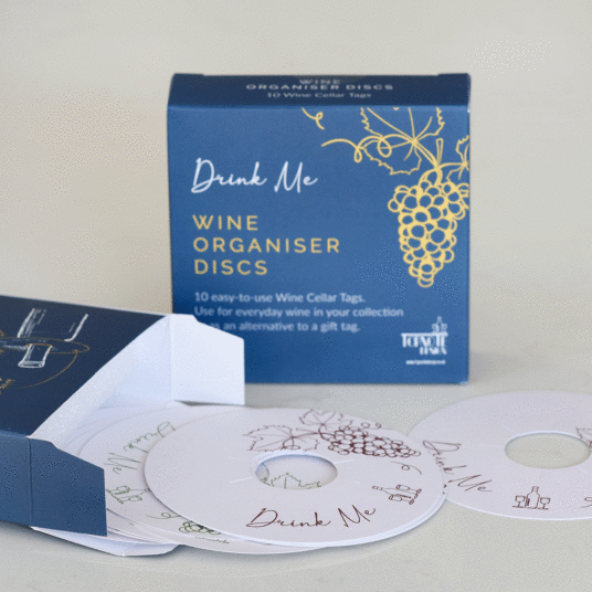 #BlindGuyAdventures | Afternoon Tea, Facial Hair, and so much Wine. A large rectangular dark blue packet that has a collection of large circular white discs in front of it that have top note design written in bold white writing, and wine cellar tags written in bold pink writing on them, on a white background.