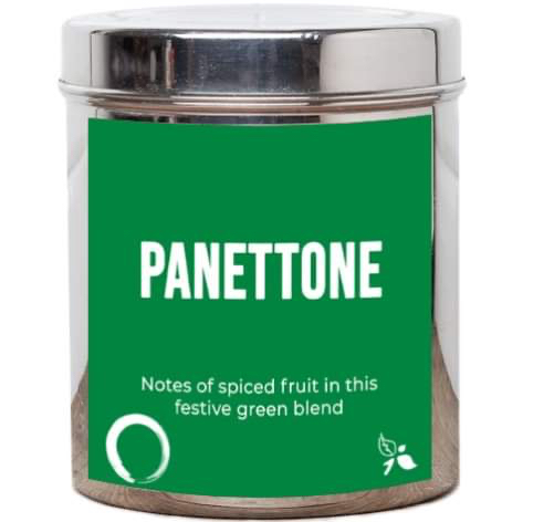 A short cylindrical silver metal tin with a black label that has bird & blend tea company Panettone Loose Leaf Tea written in bold white writing on it, on a white background.