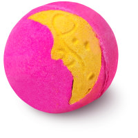 A small bright pink spherical shaped bath bomb that has some silver lustre on top of it and a bright yellow moon engraved on it, on a white background.