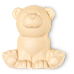 A large polar bear shaped block of bright white soap that has some eyes, a nose and a mouth engraved on it, on a white background.