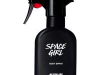 A tall black plastic kitchen spray bottle that has #LushLabs Space Girl Body Spray written in bold white writing on it, on a white background.