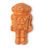 The Christmas Party Don't Start Til I Walk In | Lush Christmas 2020 Range | Bath Bombs & Bubble Bars A small bright orange clockwork man shaped bath bomb that has some gold lustre on top of it, on a white background.