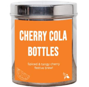 A short cylindrical silver metal tin with a bright orange label that has bird & blend tea company Cherry Cola Bottles Loose Leaf Tea written in bold white writing on it, on a white background.