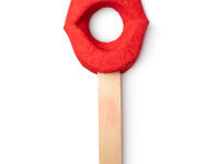 A large bright red lips shaped bubble bar that's attached to a large light wooden stick, on a white background.