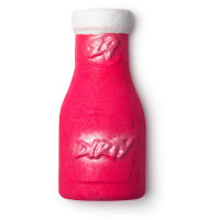 Washing The Dirt Off With A Nice Bubble Bath | Lush Dirty Perfume Bubble Bottle A large rectangular bright pink perfume shaped bubble bar that has a white wax lid and dirty written in bold sparkly pink writing on it, on a white background.