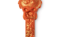 A small bright red dragons head and neck shaped bubble bar that has some gold lustre all over it, on a white background.