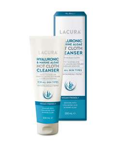 A tall conical white plastic tube with a bright white lid that has Aldi Lacura Hyaluronic & Marine Algae Hot Cloth Cleanser written in dark blue writing and a picture of a dark blue strip on it next to a tall bright white cardboard box that has Aldi Lacura Hyaluronic & Marine Algae Hot Cloth Cleanser written in dark blue writing and a picture of a dark blue strip on it, on a white background.