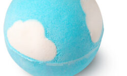 A large spherical shaped dark blue and green bath bomb that has some bright white fluffy clouds all over it, on a white background.