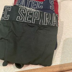 A pair of navy blue briefs with a black waistband that has separatec written in bold white writing on it next to a pair of olive green briefs with a black waistband that has separatec written in bold white writing on it and a pair of maroon briefs with a black waistband that has separatec written in bold white writing on it, on a white background.