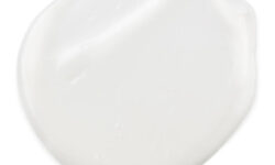 A medium circular puddle of bright white eye cream, on a white background.