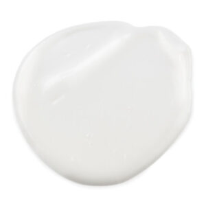 A medium circular puddle of bright white eye cream, on a white background.