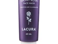 A short conical dark purple plastic tube with a bright white lid that has Aldi Lacura Ebony Rose Face Mask written in bold white writing and a picture of a bright white rose on it, on a white background.