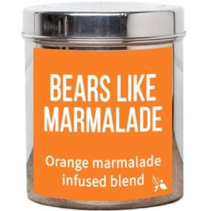 A short cylindrical silver metal tin with a bright orange label that has bird & blend tea company Bears Like Marmalade Loose Leaf Tea written in bold white writing on it, on a white background.