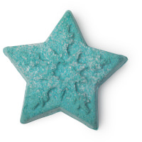 A small bright green star shaped bubble bar that has some pieces of Sea Salt embedded in the centre of it and is covered in some silver lustre, on a white background.