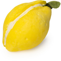 Getting Another Party Started In My Bath | Lush 30th Anniversary Bubble Bars | Phase 2 A large bright yellow lemon shaped bubble bar that has a cut In the middle of it that's filled with some bright white Cocoa Butter and is covered in some yellow lustre, on a white background.