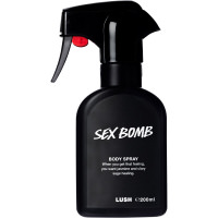 And A Partridge In A Golden Pear Tree | Lush Golden Pear Bath Bomb & Golden Pear Body Spray A tall black plastic kitchen spray bottle that has Lush Sex Bomb Body Spray written in bold white writing on it, on a white background.