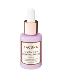 A short cylindrical clear glass bottle full of some translucent blue liquid with a silver rubber pipette lid and a white label that has Aldi Healthy Glow Plumping Serum written in bold gold writing on it, on a white background.