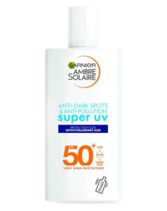 A short rectangular white plastic bottle with a white plastic lid that has Garnier Ambre Solaire written in bold black writing, Super UV written in light blue writing, Face Fluid SPF50+ written in bold gold writing, and a picture of a dark blue stripe on it, on a white background.