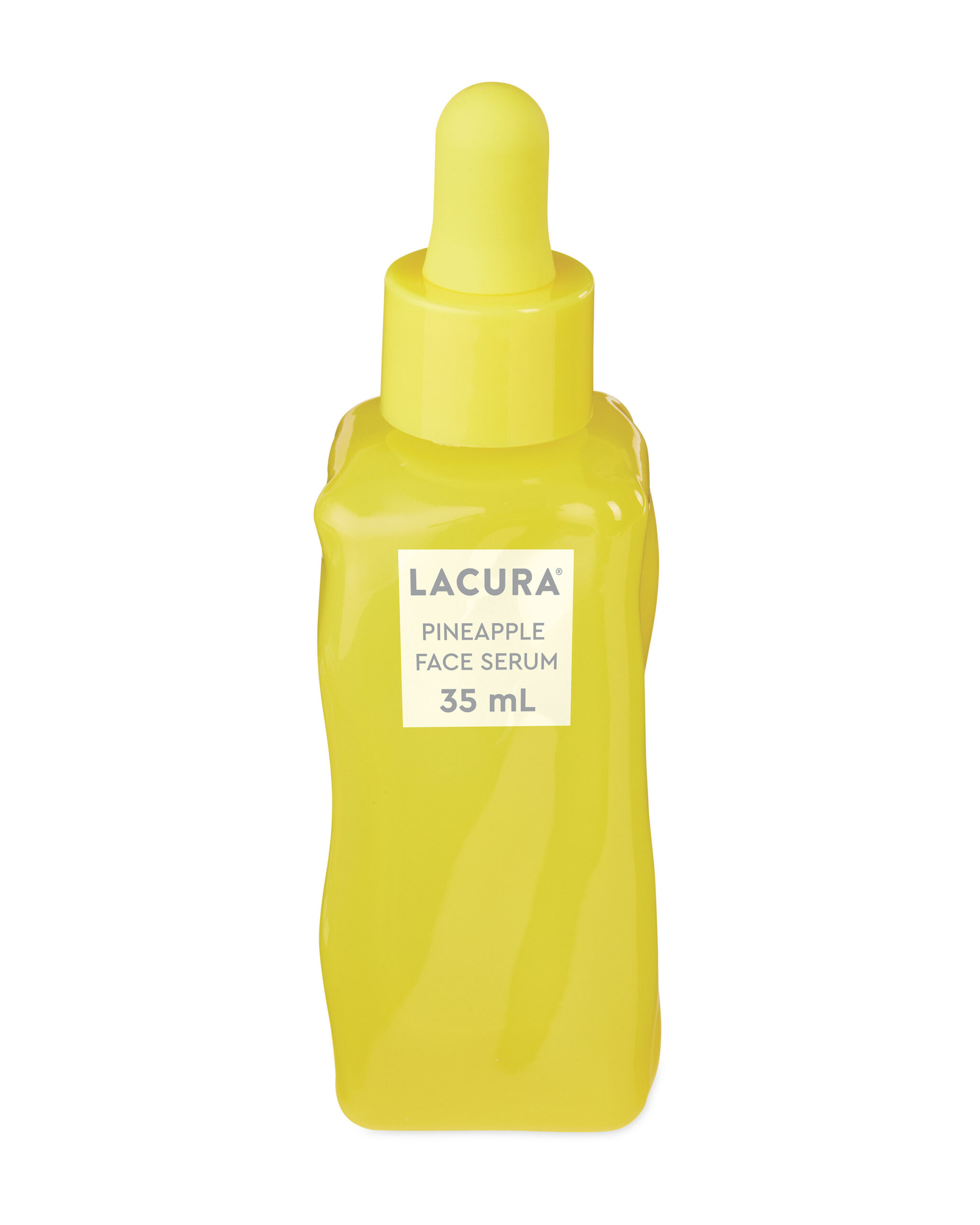 Stuffing My Face Full Of Pineapple | Aldi Lacura Pineapple Face Serum A tall rectangular yellow glass bottle full of some clear liquid with a yellow rubber pipette lid and a white label that has Aldi Lacura Pineapple Face Serum written in bold black writing on it, on a white background.