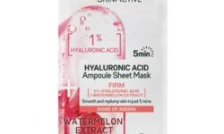 A tall rectangular white plastic pouch that has Garnier SkinActive Hyaluronic Acid Firming Ampoule Sheet Mask written in bold green writing and a picture of a slice of Watermelon inside a plastic capsule on it, on a white background.
