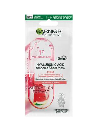 A tall rectangular white plastic pouch that has Garnier SkinActive Hyaluronic Acid Firming Ampoule Sheet Mask written in bold green writing and a picture of a slice of Watermelon inside a plastic capsule on it, on a white background.
