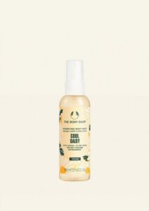 A tall cylindrical clear plastic bottle full of some pale yellow liquid with a black plastic spray pump lid that has The Body Shop Cool Daisy Hydrating Body Mist written in dark green writing and some pictures of some pale yellow Daisies on it, on a white background.