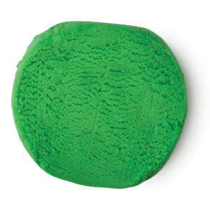 A large cylindrical block of bright green plasticine, on a white background.