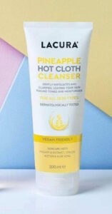 A tall conical white plastic tube with a bright white lid that has Aldi Lacura Pineapple Hot Cloth Cleanser written in bright yellow writing and a picture of a bright yellow stripe on it, on a white background.
