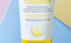 A tall conical white plastic tube with a bright white lid that has Aldi Lacura Pineapple Hot Cloth Cleanser written in bright yellow writing and a picture of a bright yellow stripe on it, on a white background.