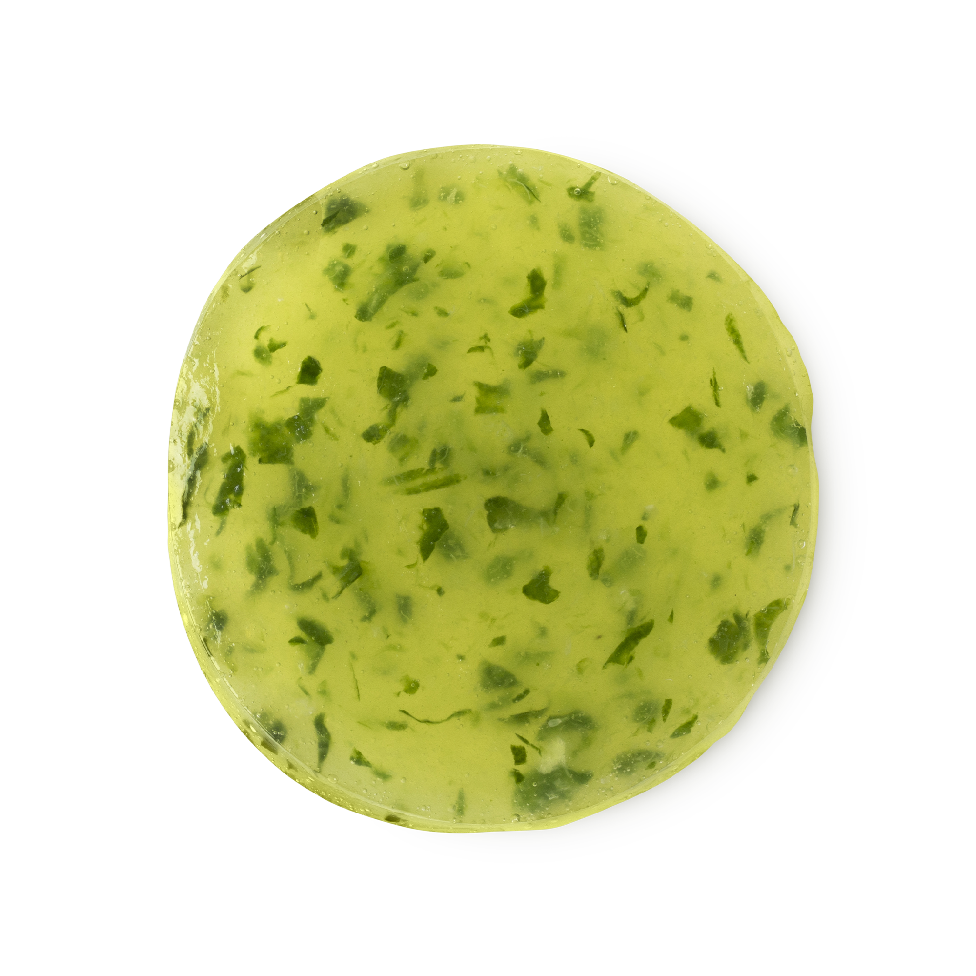 A large circular bright green eye pad that has some pieces of Cucumber Puree running all the way through it, on a white background.