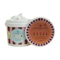 I Wonder Just How Much Sugar Is Actually In A Cola Bottle? | The Yorkshire Soap Company Cola Bottles Soap & Sugar Whip Scrub A short cylindrical white plastic tub with a pink and black striped label that has The Yorkshire Soap Company Cola Bottles Soap & Sugar Whip Scrub written in dark blue writing and some pictures of some bright white ice creams on it, on a white background.