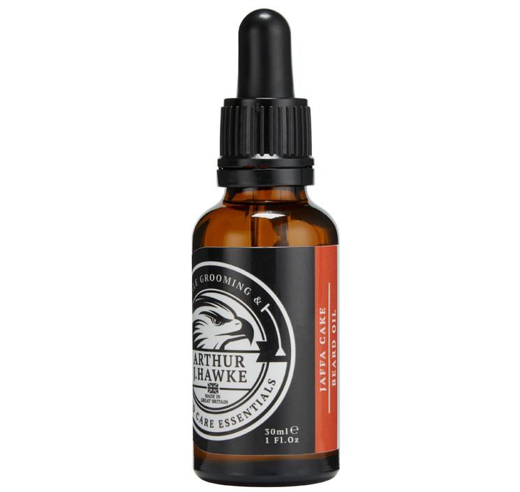 Full Beard, Half Beard, Total Beard | Arthur J Hawke Jaffa Cake Beard Oil A short cylindrical brown glass bottle with a black rubber pipette lid and a white label that has Arthur J Hawke Jaffa Cake Beard Oil written in bold white writing and a picture of a black and white hawk on it, on a white background.
