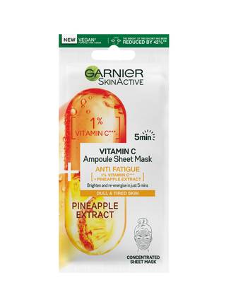 Take An Ampoule Of This For Awakened Skin | Garnier SkinActive Vitamin C Anti Fatigue Ampoule Sheet Mask A tall rectangular white plastic pouch that has Garnier SkinActive Vitamin C Anti Fatigue Ampoule Sheet Mask written in bold green writing and a picture of a large bright orange and yellow Vitamin C Tablet on it, on a white background.